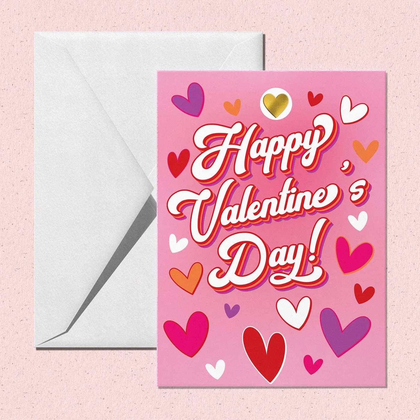 Valentine's card in retro white script ringed by hearts in pink, red and purple, one of them gold foil, beside a white envelope