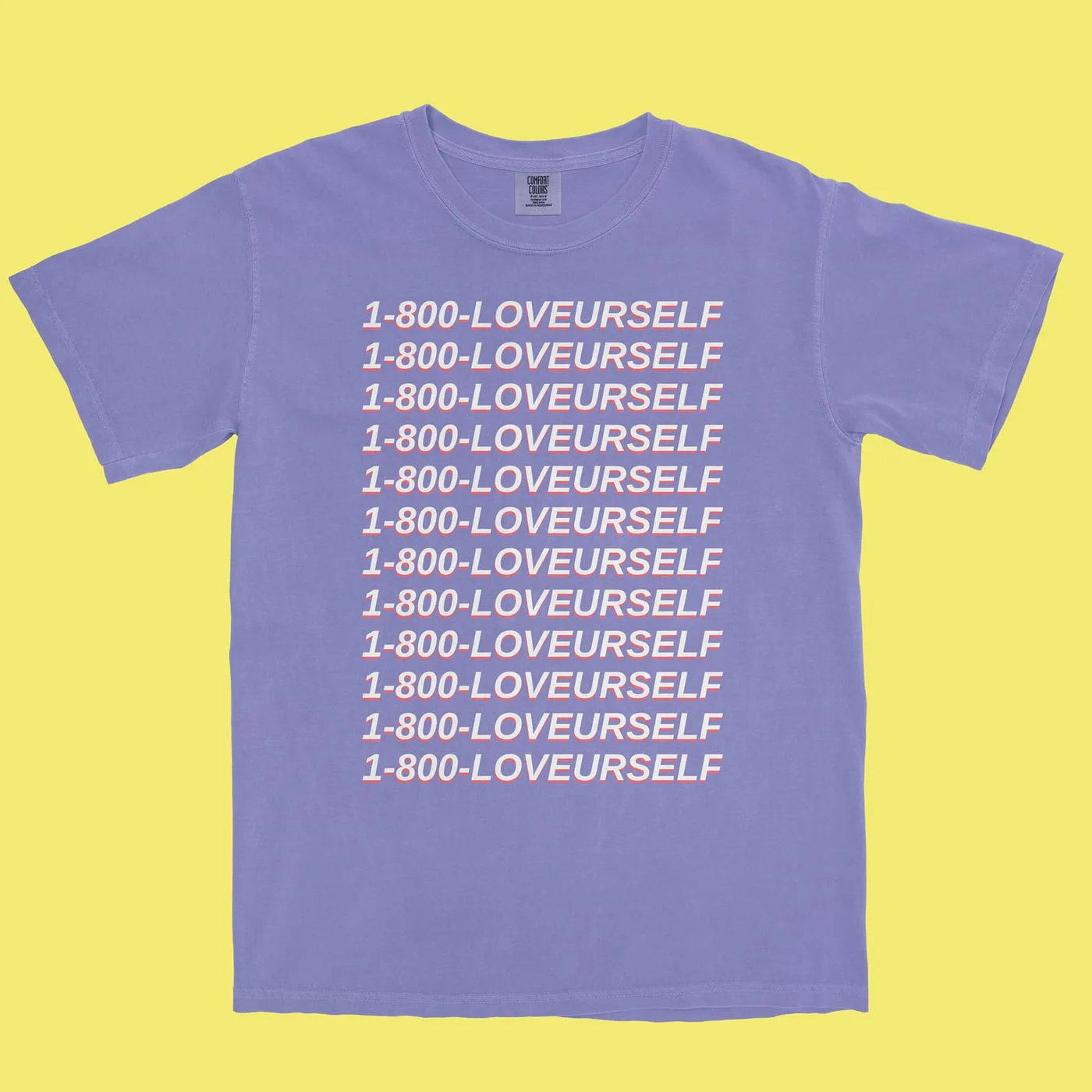 Periwinkle tee printed with 1-800-LOVEURSELF repeated in twelve italic rows with a coral offset