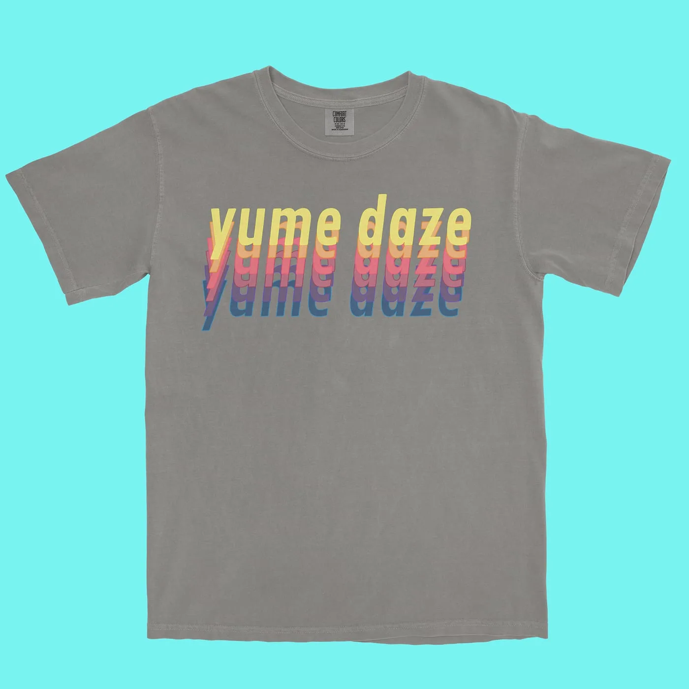 Stone tee with the wordmark echoed four times in yellow, coral, purple and blue